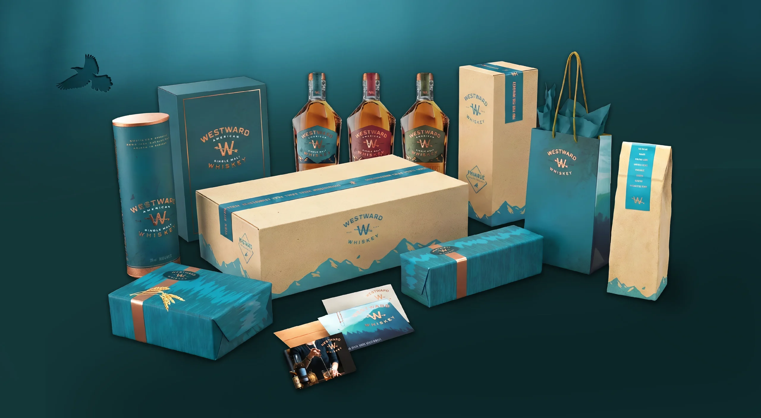 Westward Whiskey brand design system featuring premium gift packaging including secondary packaging canisters, gift boxes, branded wrapping paper, shopping bags, and shipping case.