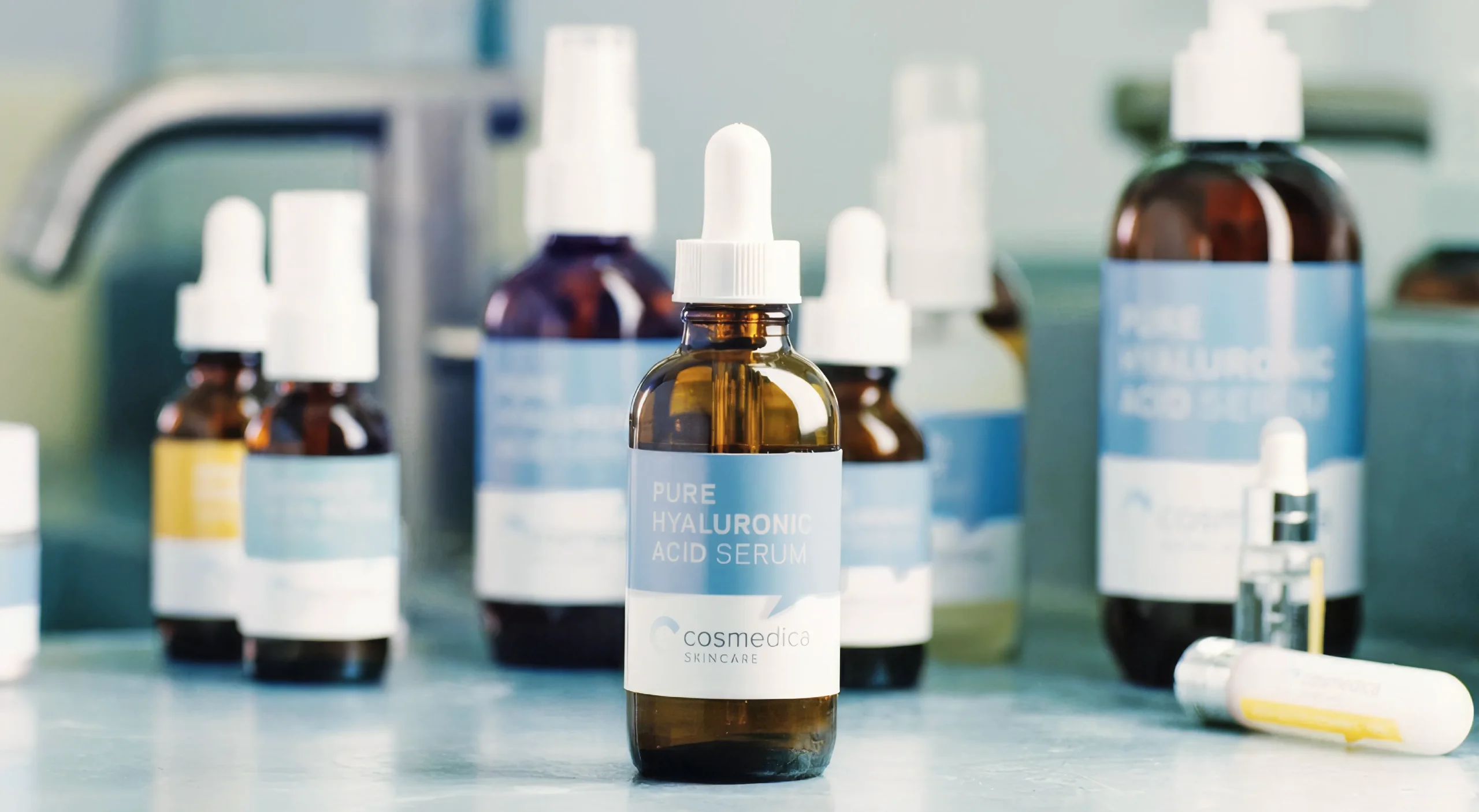 Cosmedica Skincare brand design system featuring premium package design, product label typography, and visual identity for clinical-grade facial serums and moisturizers.